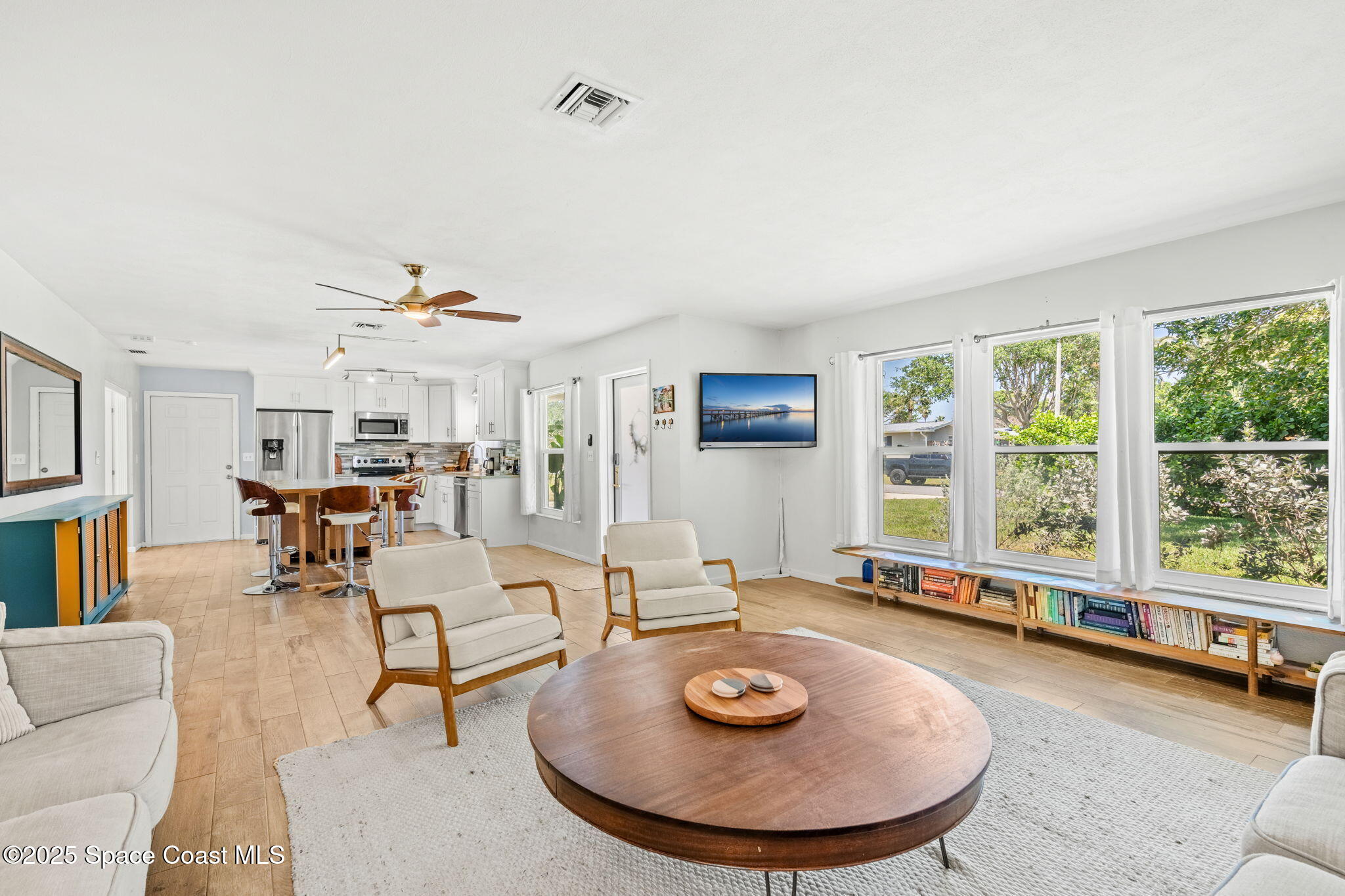 411 Poinsettia Road Melbourne Beach, FL 32951 - Photo 14 of 78 a living room with furniture and a large window