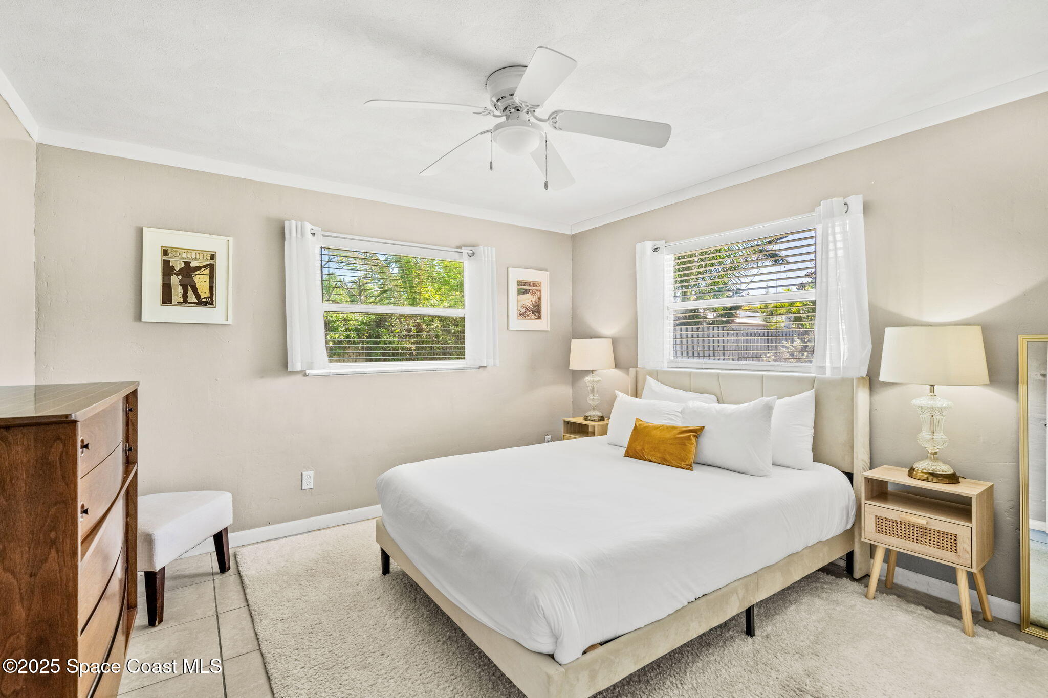 411 Poinsettia Road Melbourne Beach, FL 32951 - Photo 19 of 78 a bedroom with a bed and window