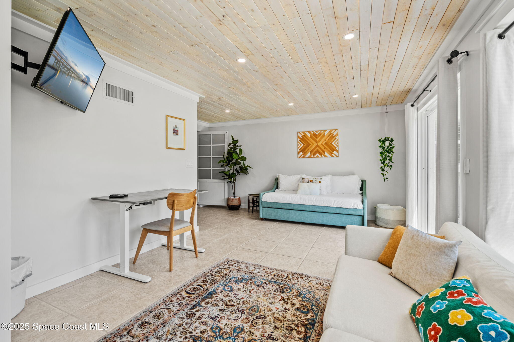 411 Poinsettia Road Melbourne Beach, FL 32951 - Photo 24 of 78 a living room with furniture and a rug