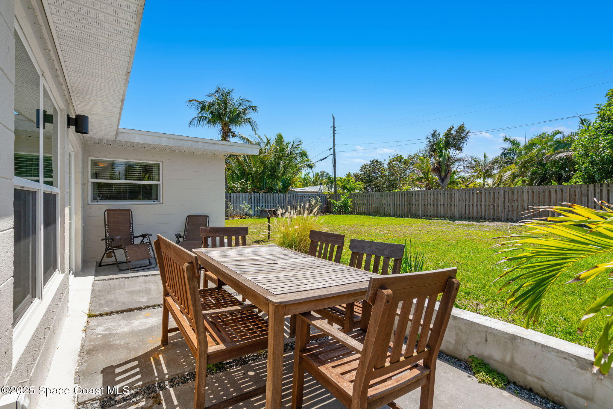 411 Poinsettia Road Melbourne Beach, FL 32951 - Photo 28 of 78 a view of a chairs and table on the deck
