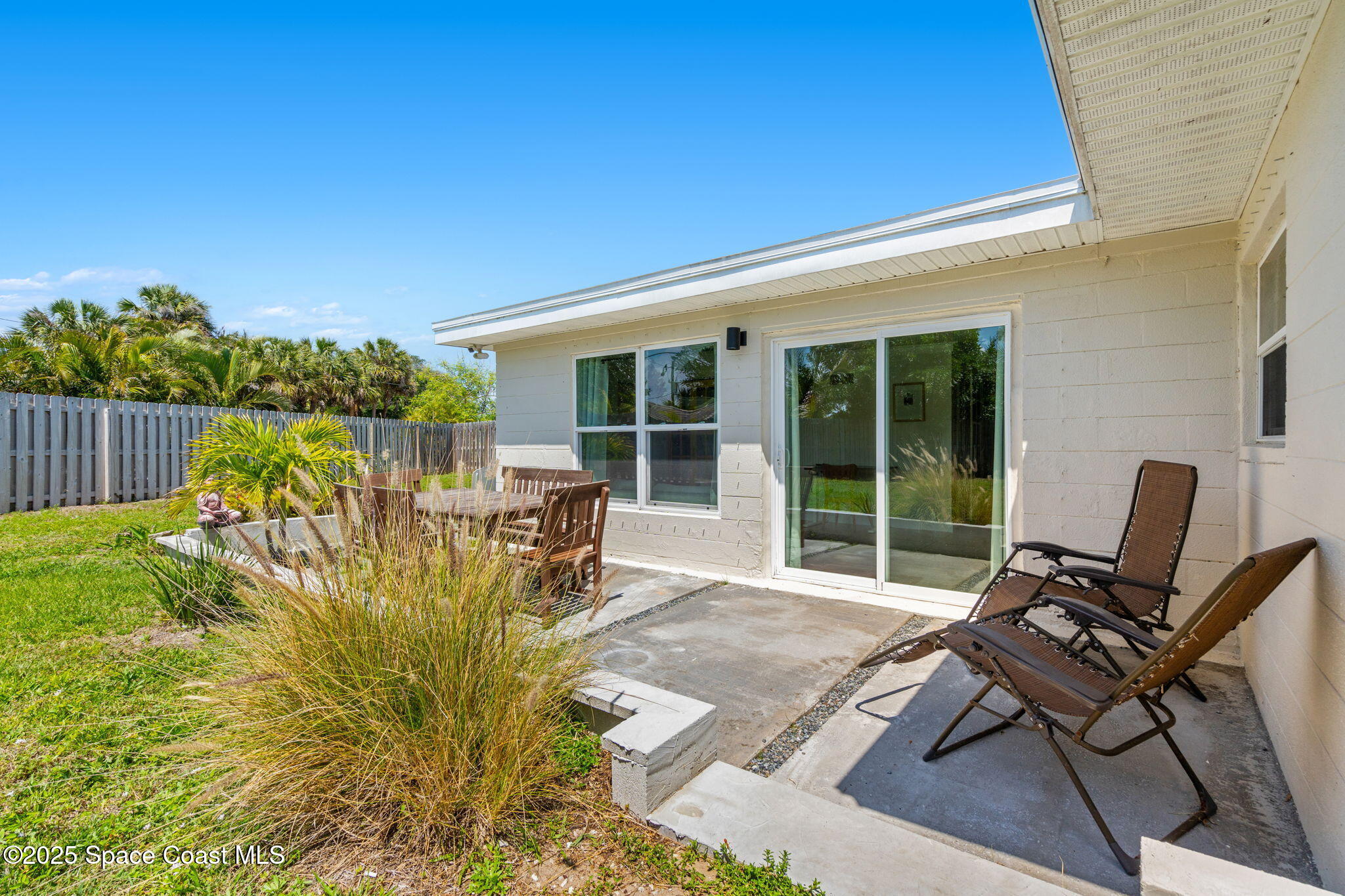 411 Poinsettia Road Melbourne Beach, FL 32951 - Photo 30 of 78 a house view with a seating space and garden view