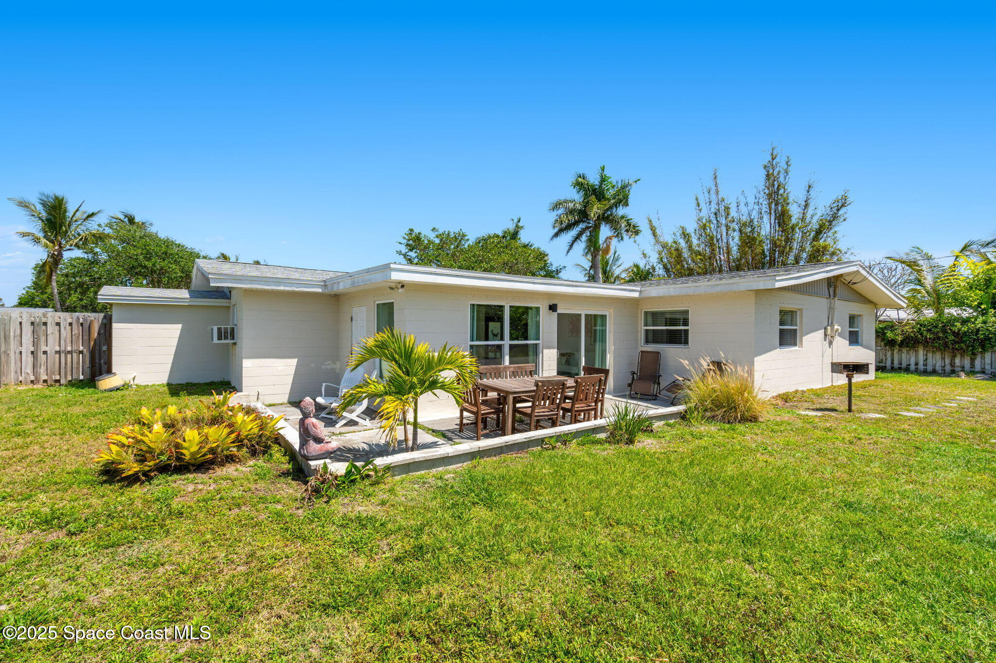 411 Poinsettia Road Melbourne Beach, FL 32951 - Photo 32 of 78 a front view of house with yard and seating area