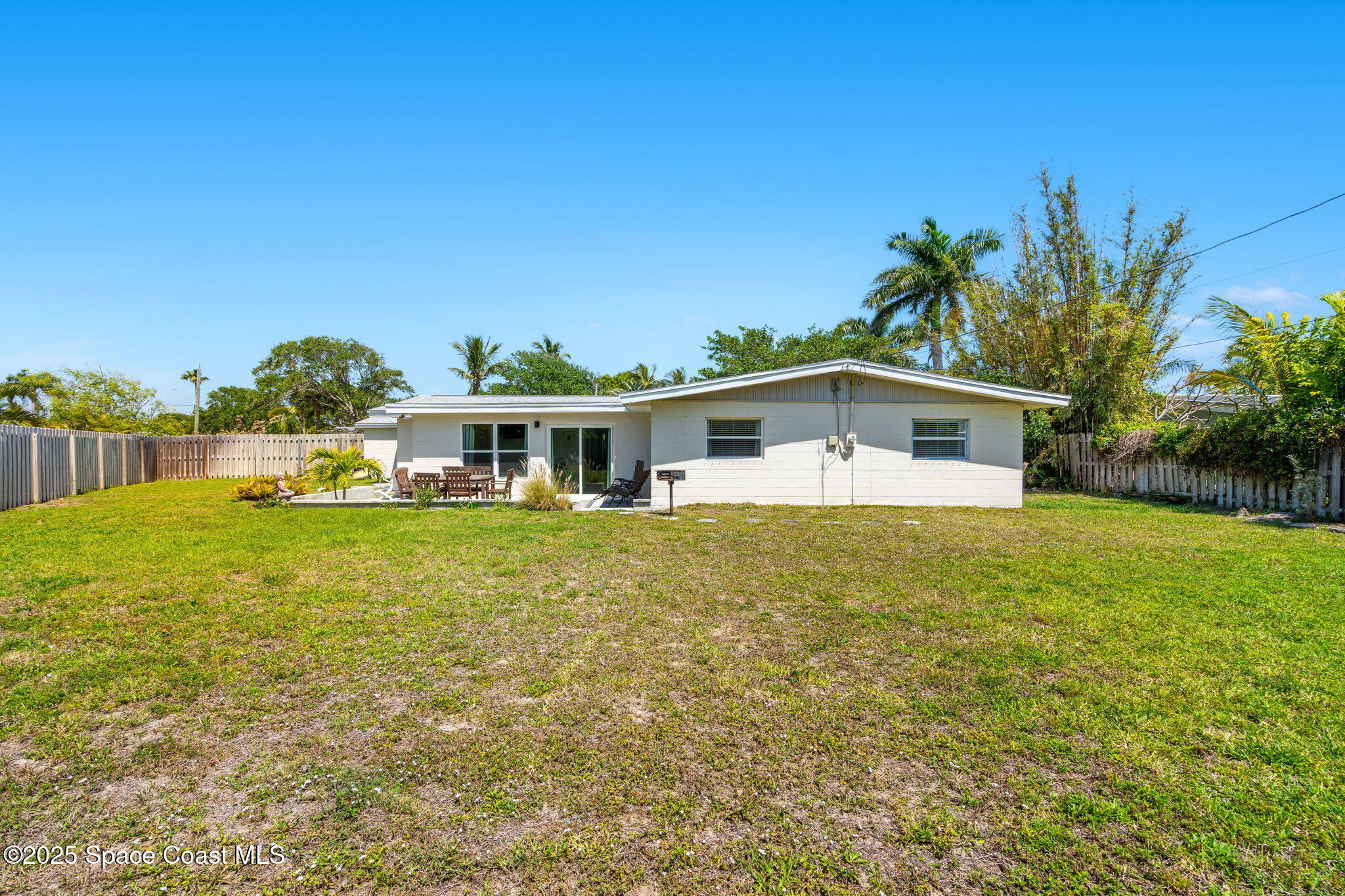 411 Poinsettia Road Melbourne Beach, FL 32951 - Photo 39 of 78 a front view of a house with a yard