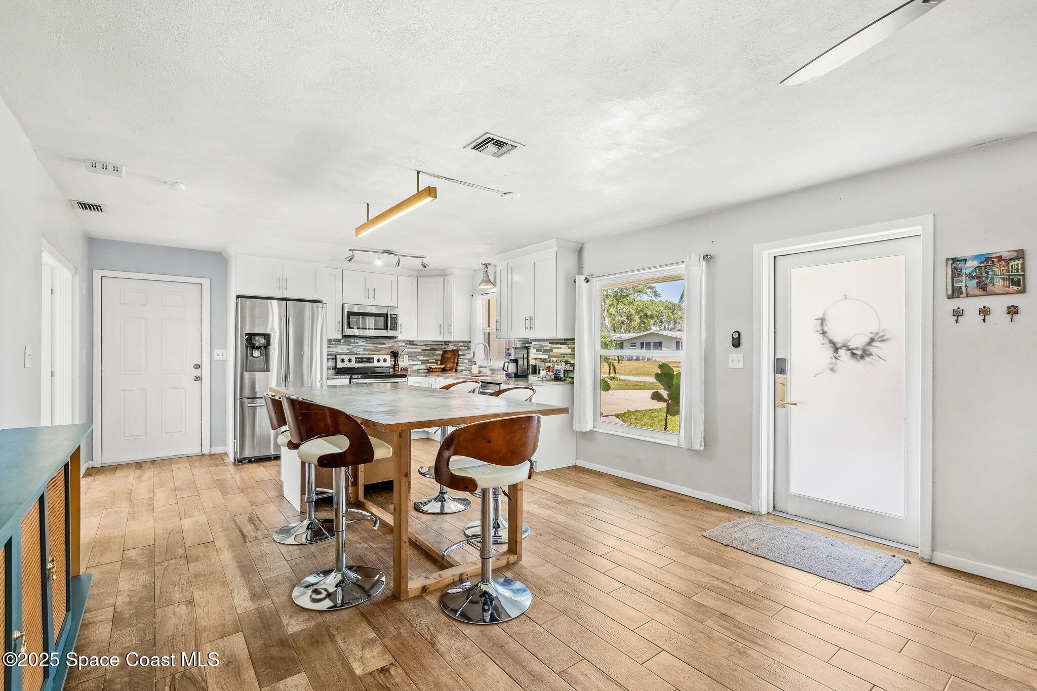 411 Poinsettia Road Melbourne Beach, FL 32951 - Photo 4 of 78 a view of a dining room with furniture and wooden floor