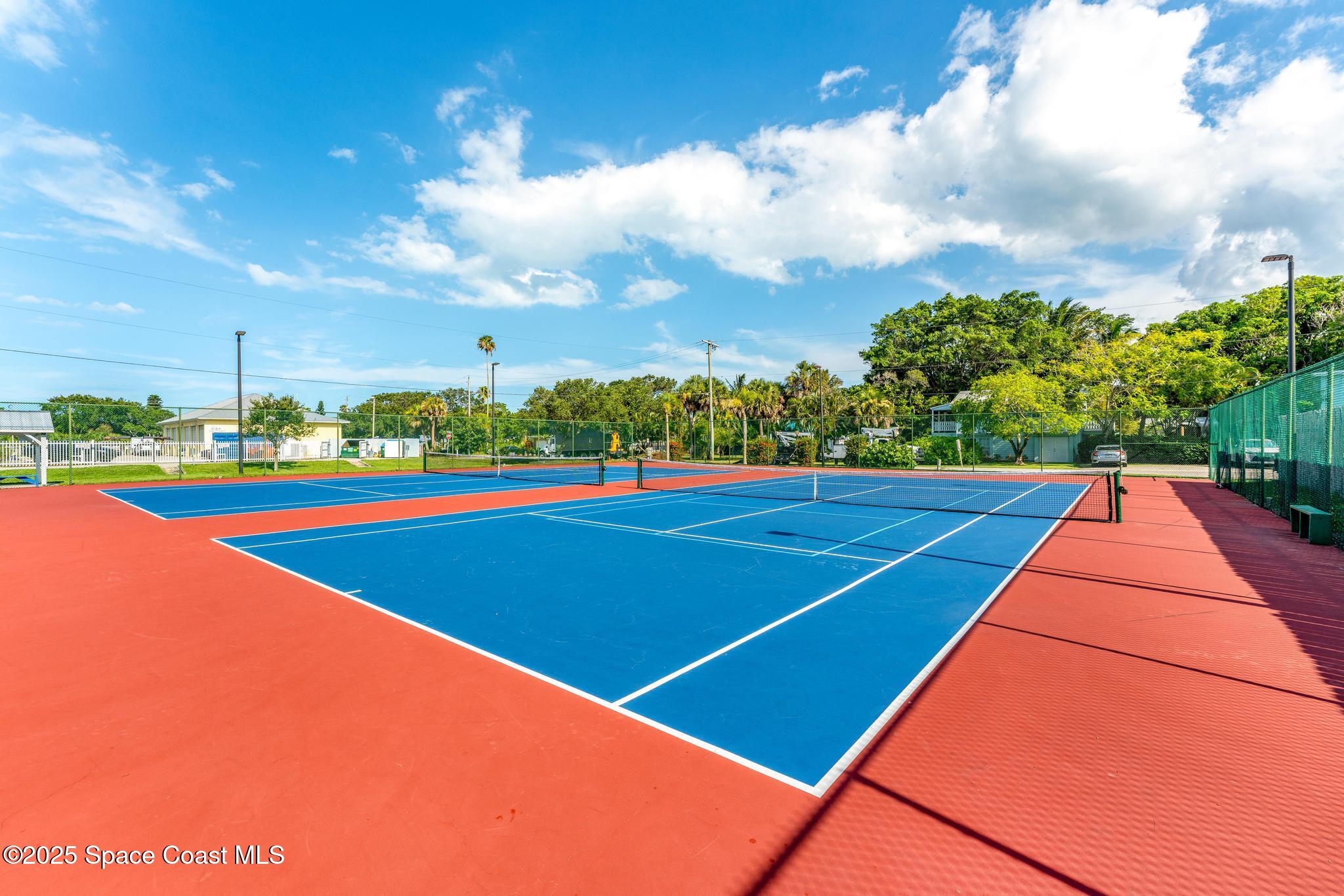 411 Poinsettia Road Melbourne Beach, FL 32951 - Photo 55 of 78 a view of an outdoor space and tennis court
