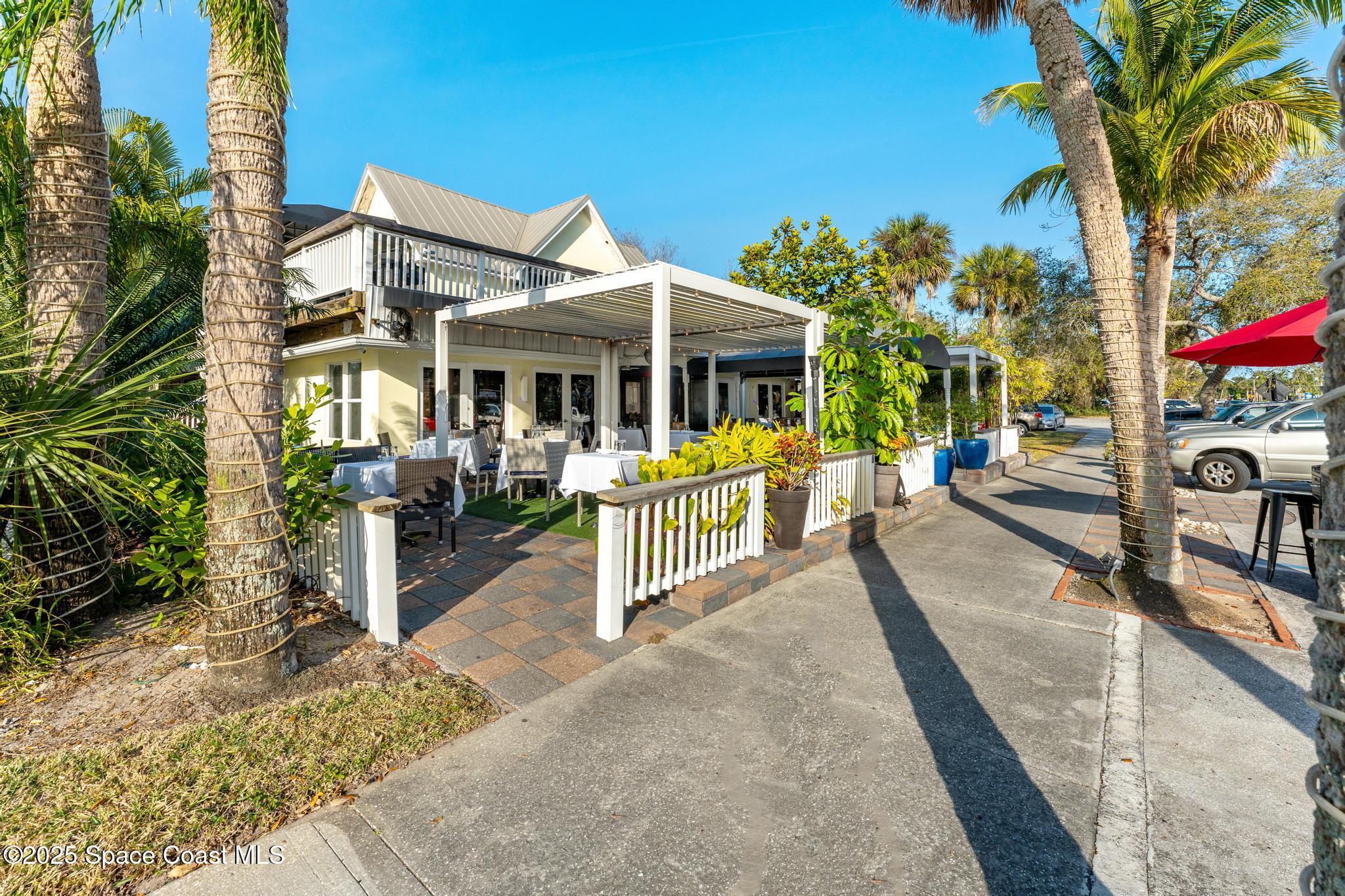 411 Poinsettia Road Melbourne Beach, FL 32951 - Photo 61 of 78 a view of a house with backyard and sitting area