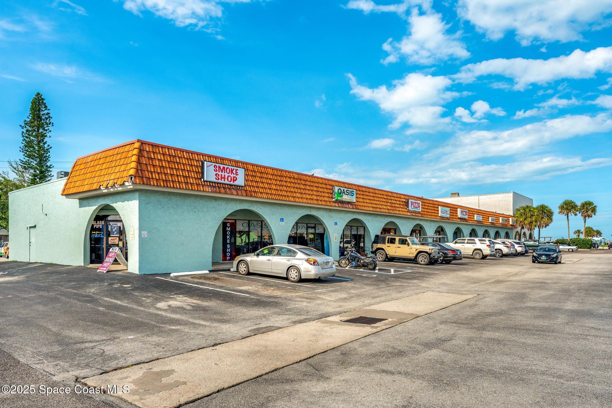 411 Poinsettia Road Melbourne Beach, FL 32951 - Photo 64 of 78 a view of a cars park in front of a building