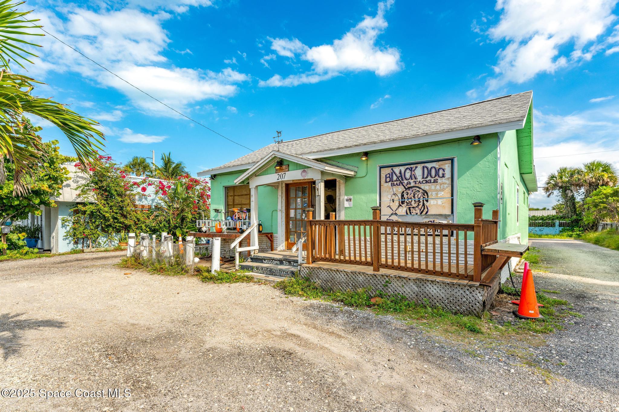 411 Poinsettia Road Melbourne Beach, FL 32951 - Photo 67 of 78 a view of a house with a patio and a yard