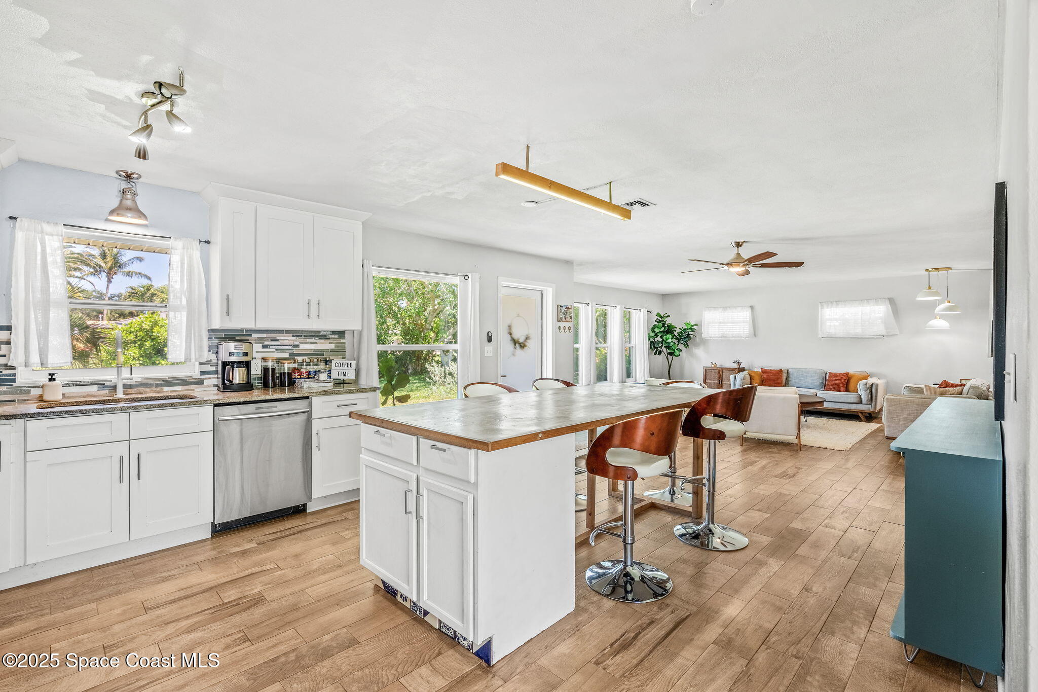 411 Poinsettia Road Melbourne Beach, FL 32951 - Photo 10 of 78 a kitchen with stainless steel appliances granite countertop a stove and cabinets