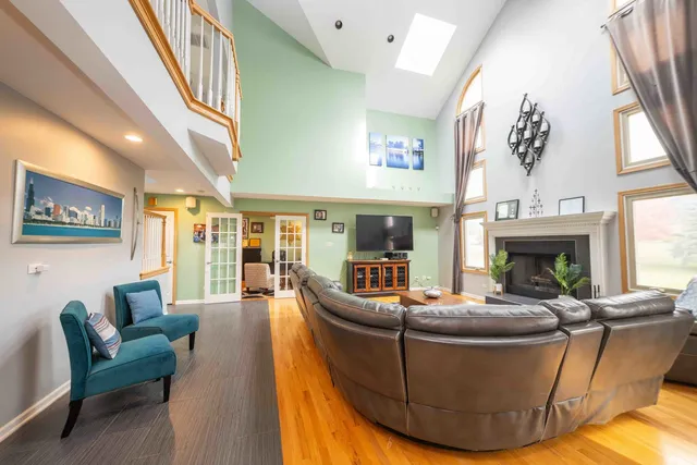 a living room with furniture a fireplace and a large window