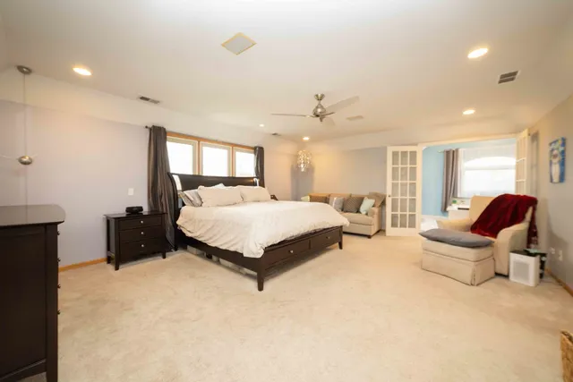 a spacious bedroom with a bed and furniture