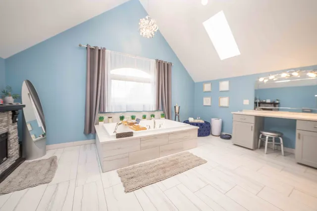 a large bedroom with a large bed and a large window