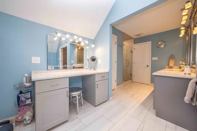 a bathroom with a sink vanity and mirror