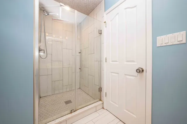 a bathroom with a glass shower door