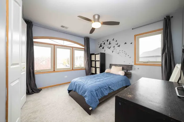 a bedroom with a large bed and a large window