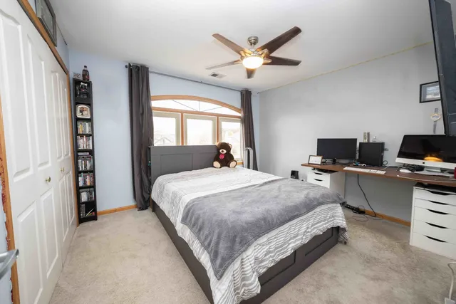 a bedroom with a bed and a tv