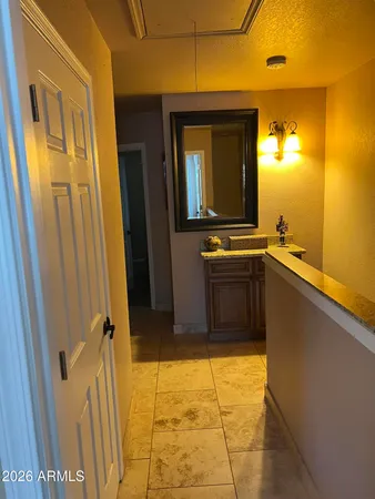 a bathroom with a granite countertop sink and a mirror
