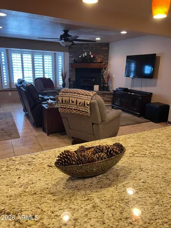 a living room with furniture a flat screen tv and a dining table