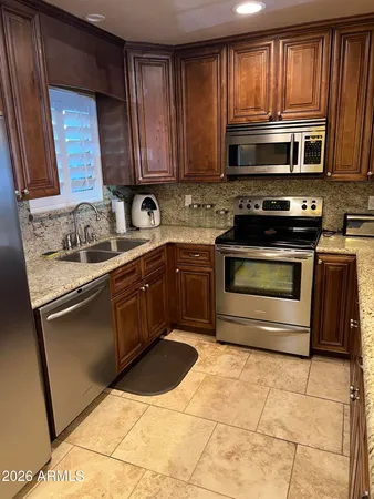 a kitchen with a sink stove and microwave
