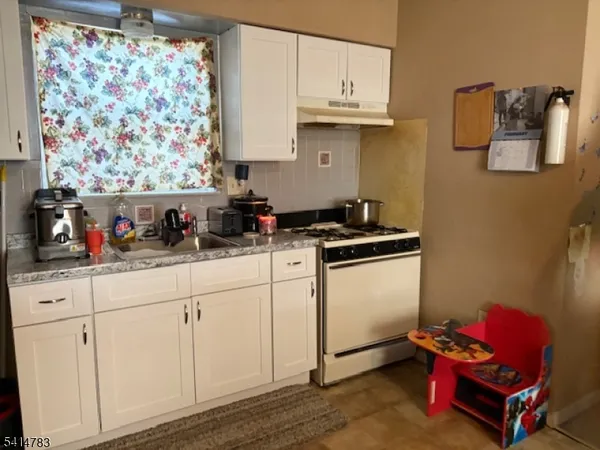 a kitchen with stainless steel appliances white cabinets and a sink