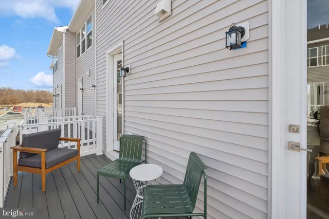 a balcony with table and chairs