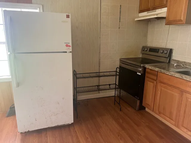 a kitchen with a refrigerator and a stove