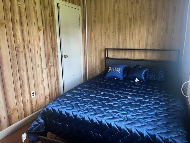 a bedroom with a bed and a window