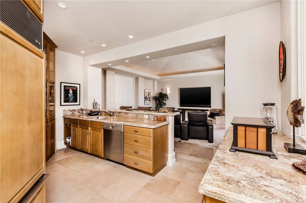 33 Monarch Bay Drive Dana Point, CA 92629 - Photo 12 of 46 a open kitchen with stainless steel appliances granite countertop a stove top oven a sink and a refrigerator