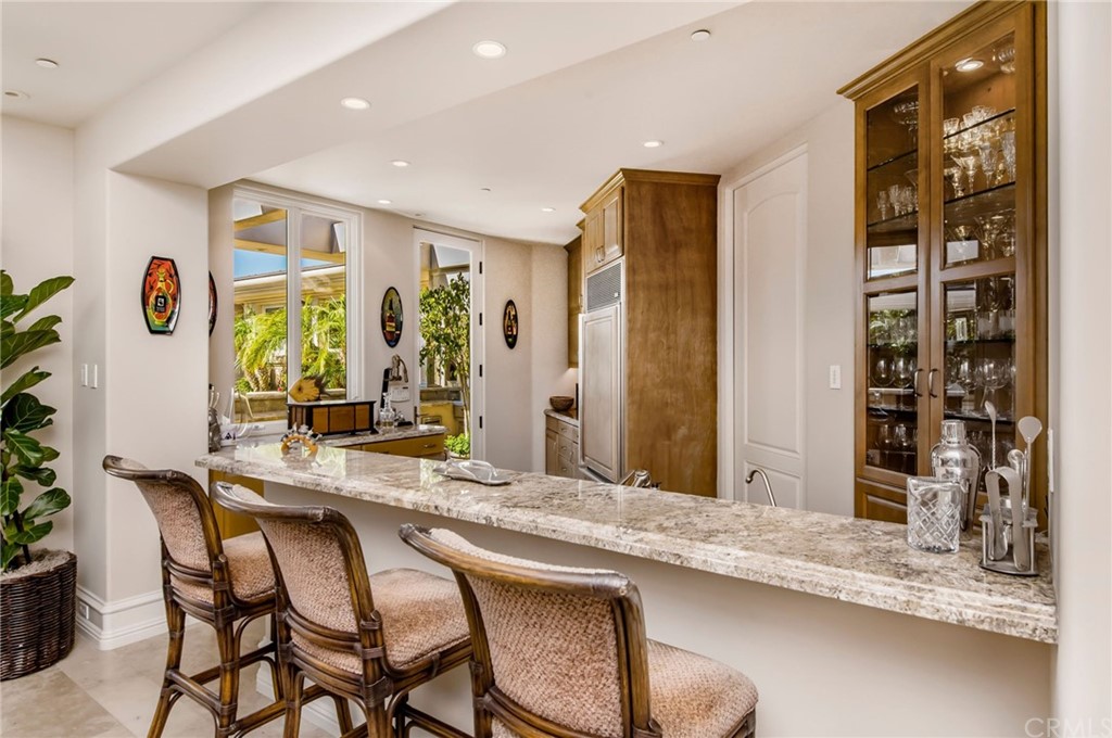 33 Monarch Bay Drive Dana Point, CA 92629 - Photo 13 of 46 a dining hall with stainless steel appliances granite countertop a dining table and chairs with wooden floor