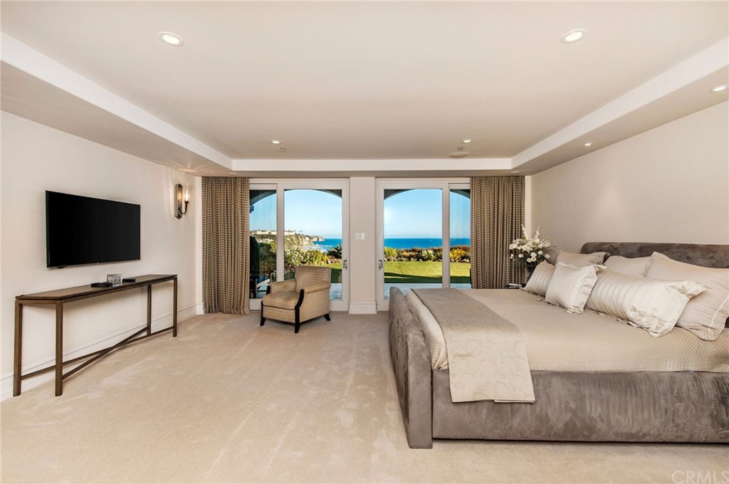 33 Monarch Bay Drive Dana Point, CA 92629 - Photo 15 of 46 a living room with a flat screen tv and a large window