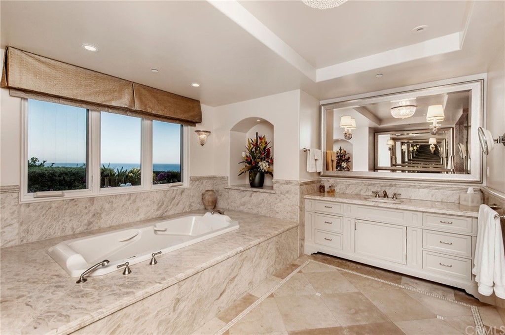 33 Monarch Bay Drive Dana Point, CA 92629 - Photo 16 of 46 a large bathroom with a large tub sink and glass door