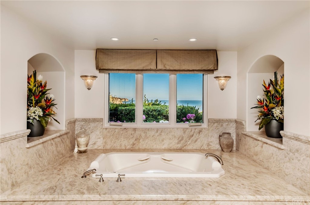 33 Monarch Bay Drive Dana Point, CA 92629 - Photo 17 of 46 a bathroom with a tub sink and a mirror