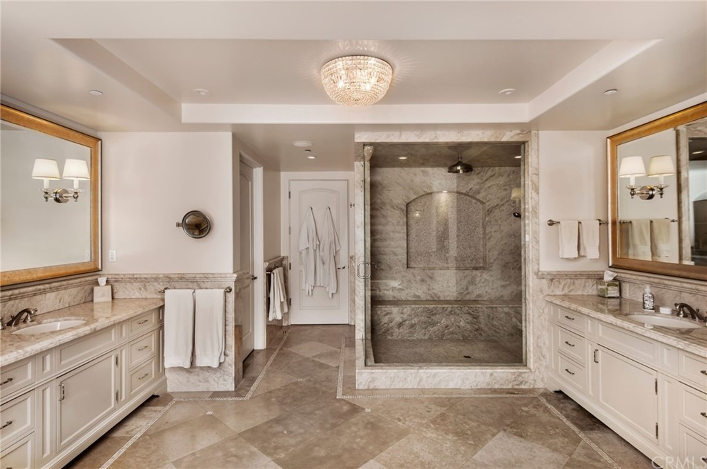 33 Monarch Bay Drive Dana Point, CA 92629 - Photo 18 of 46 a spacious bathroom with a shower sink and mirror