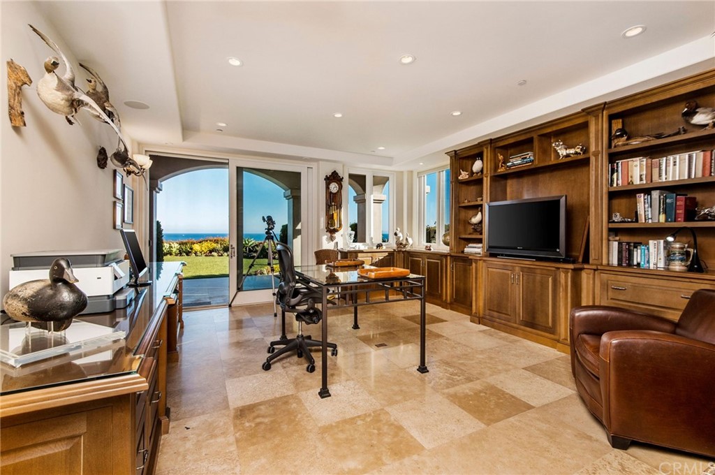33 Monarch Bay Drive Dana Point, CA 92629 - Photo 23 of 46 a living room with furniture a rug and a flat screen tv