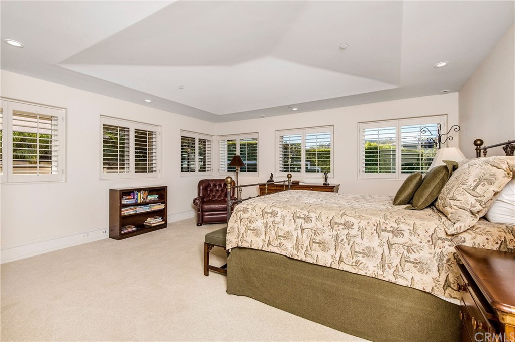 33 Monarch Bay Drive Dana Point, CA 92629 - Photo 28 of 46 a bed sitting in a bedroom next to a window with a dresser
