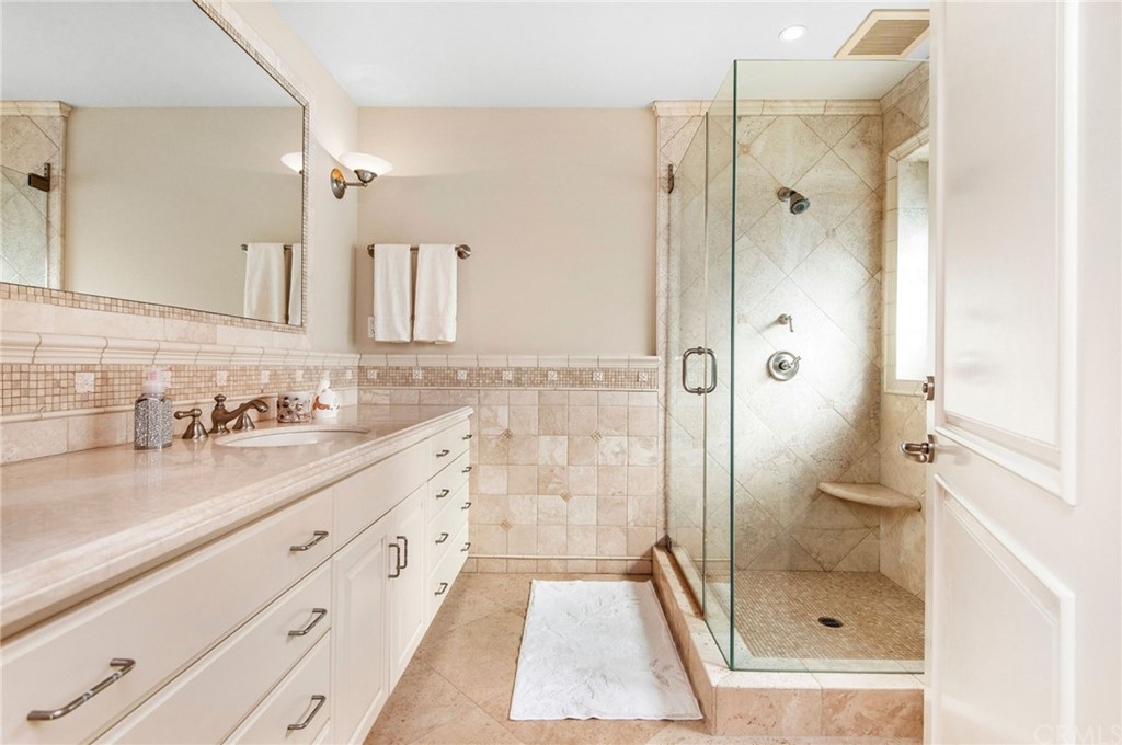 33 Monarch Bay Drive Dana Point, CA 92629 - Photo 29 of 46 a bathroom with a granite countertop sink shower and a mirror