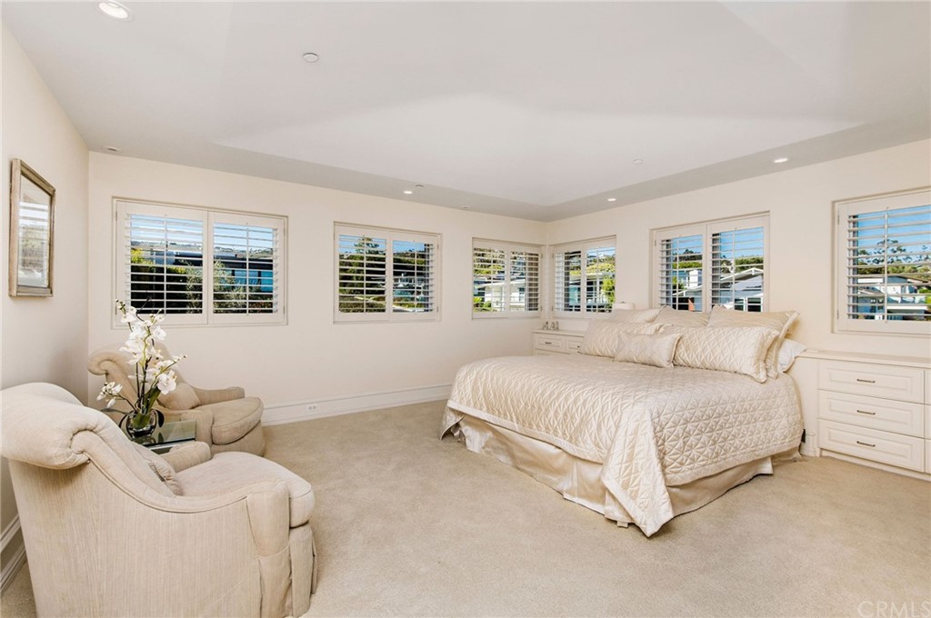 33 Monarch Bay Drive Dana Point, CA 92629 - Photo 34 of 46 a spacious bedroom with a bed and glass window