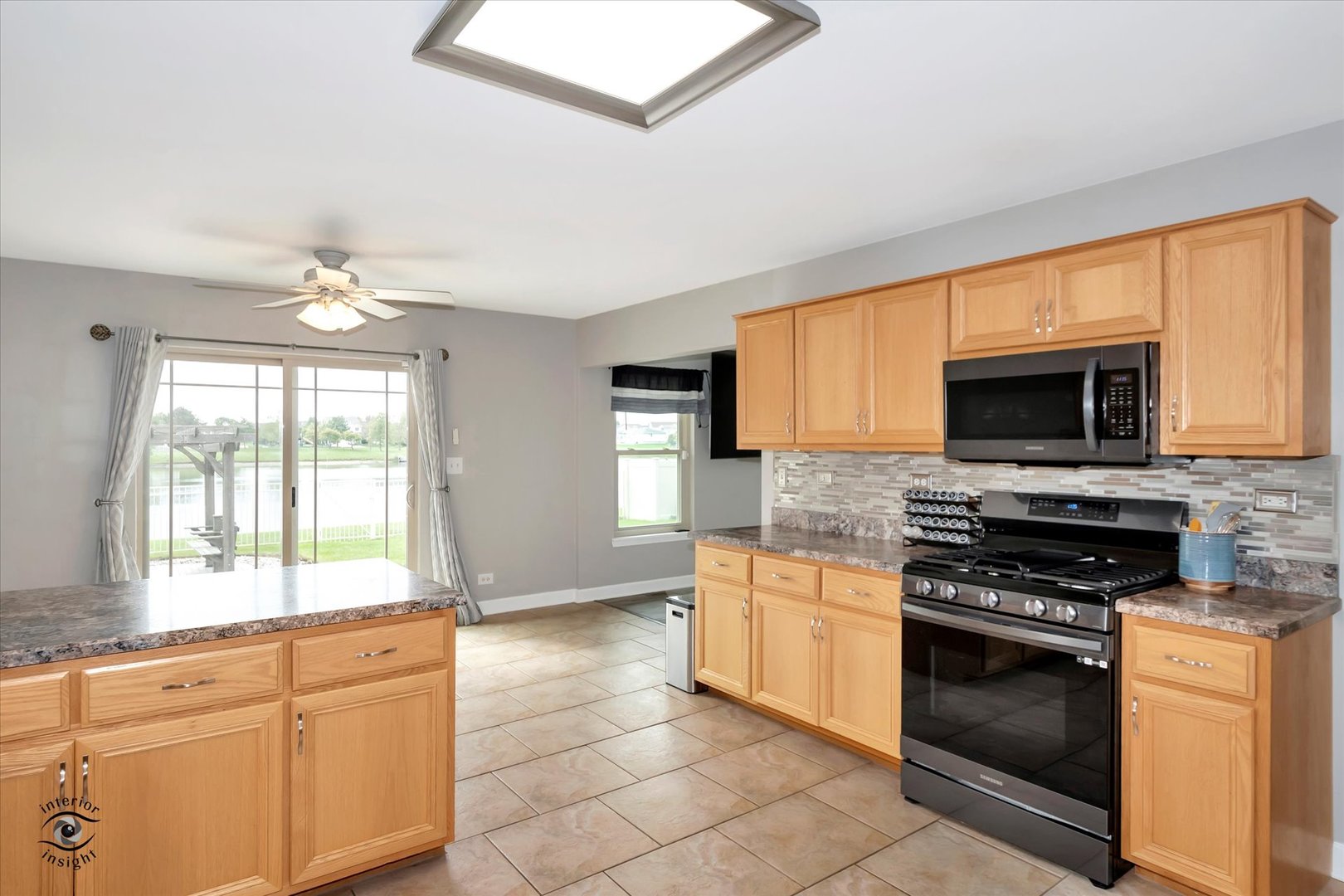 16364 Celtic Circle Manhattan, IL 60442 - Photo 11 of 31 a kitchen with stainless steel appliances a stove sink and microwave