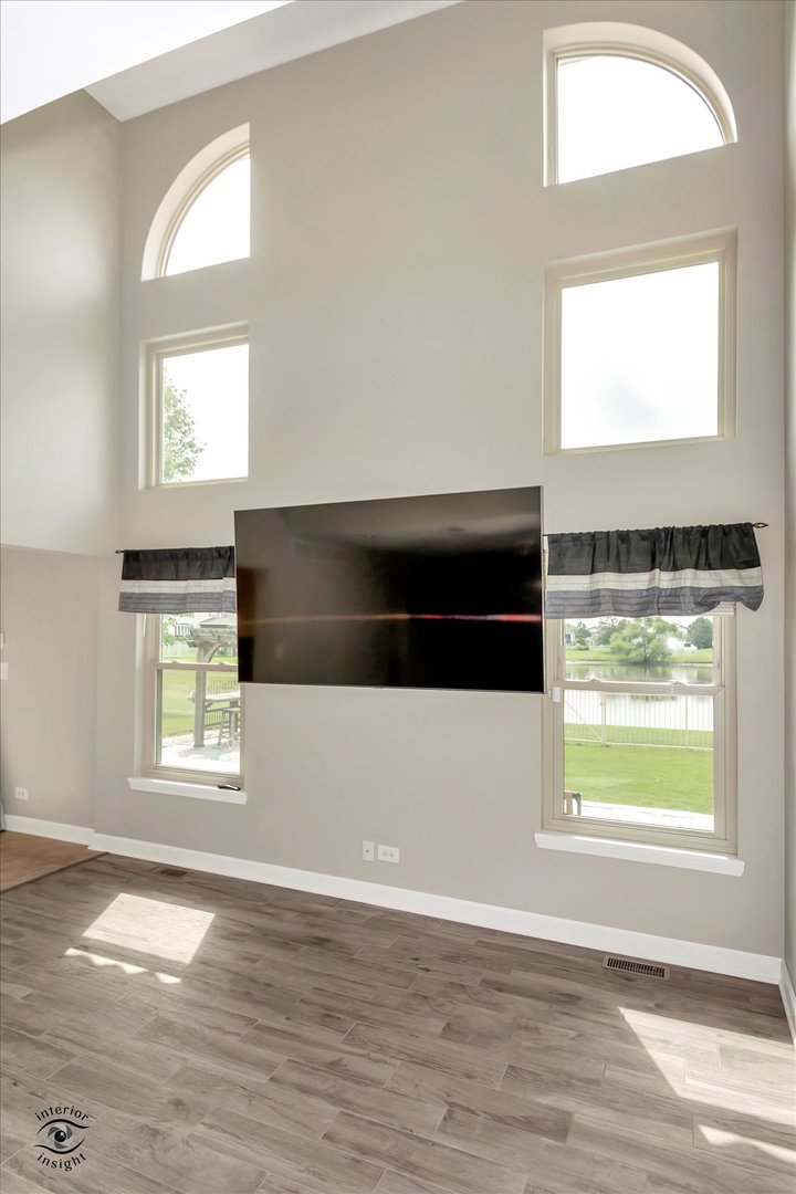 16364 Celtic Circle Manhattan, IL 60442 - Photo 8 of 31 a view of an empty room with a window and wooden floor