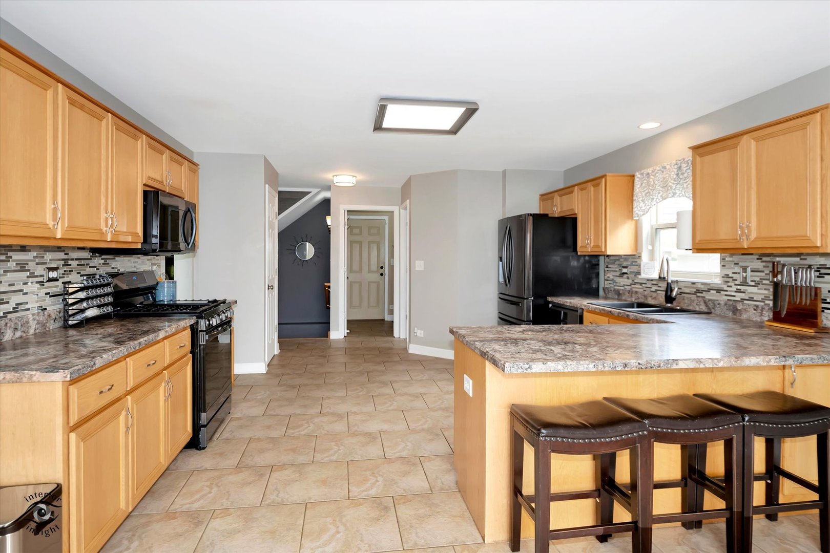 16364 Celtic Circle Manhattan, IL 60442 - Photo 10 of 31 a kitchen with stainless steel appliances granite countertop a stove top oven a sink dishwasher a dining table and chairs with wooden floor