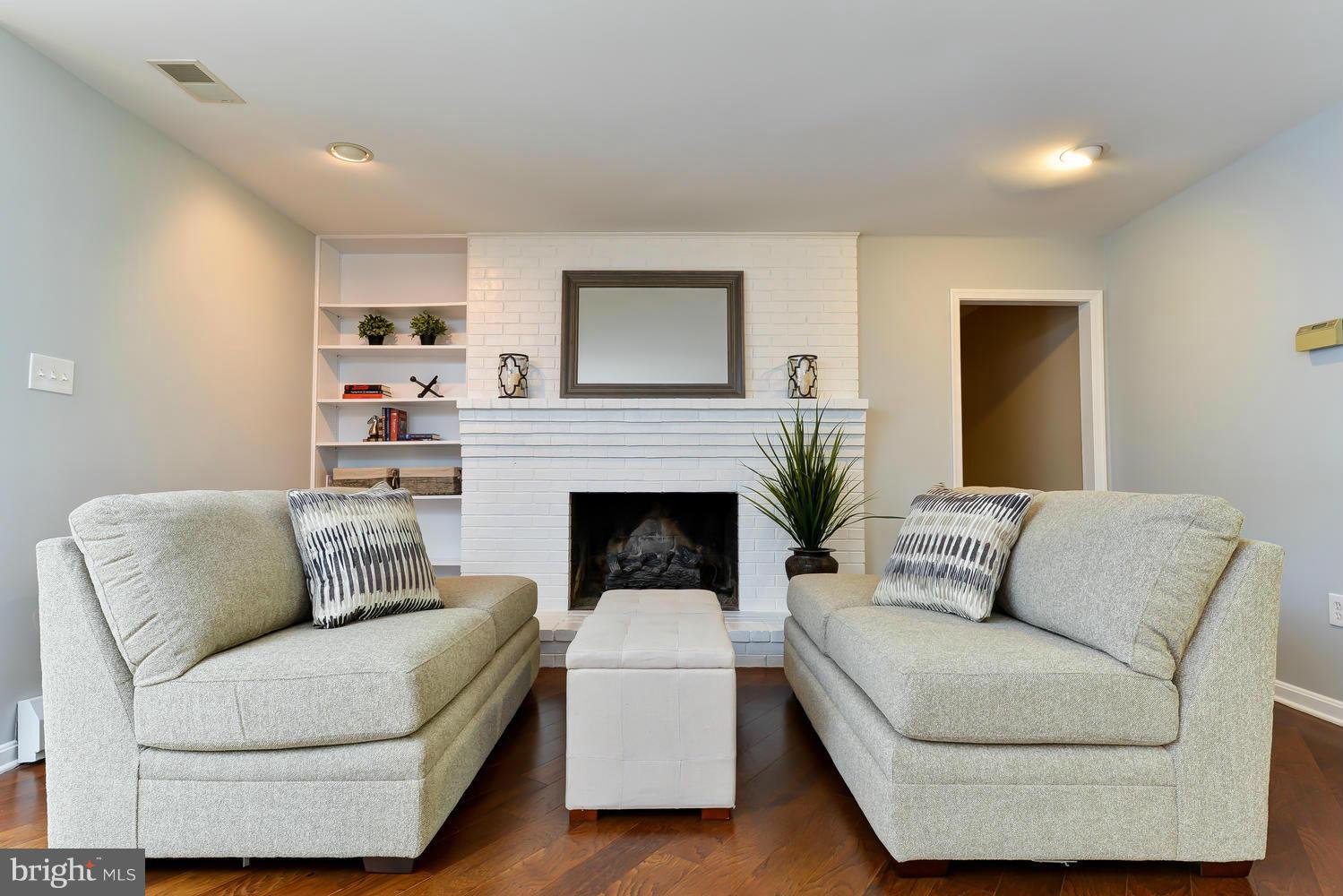 243 Springvale Road Great Falls, VA 22066 - Photo 13 of 30 a living room with furniture and a fireplace