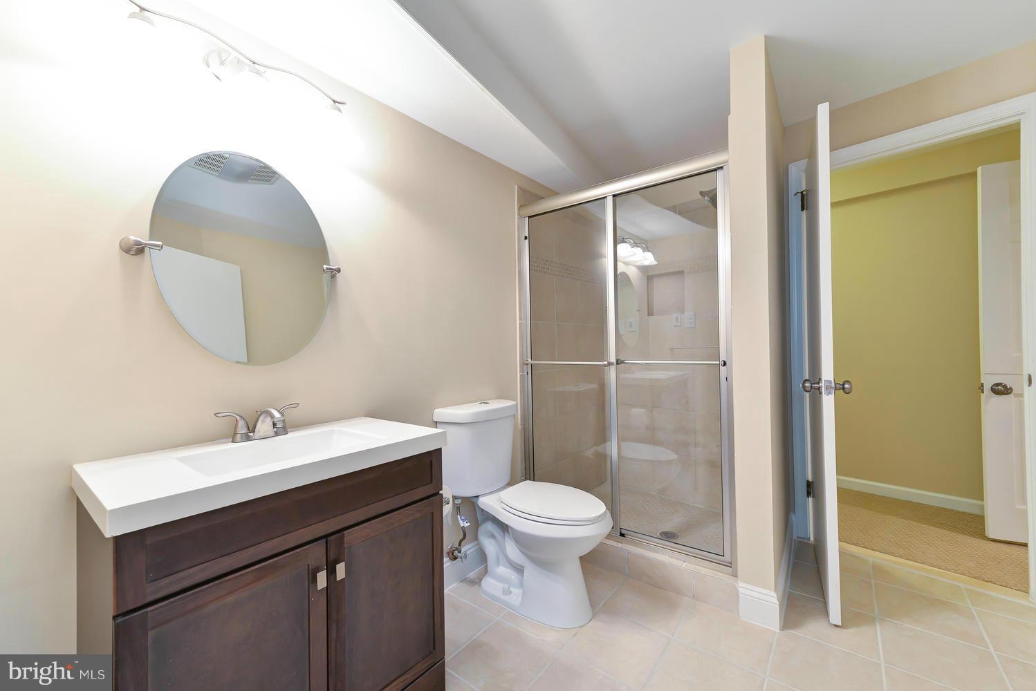 243 Springvale Road Great Falls, VA 22066 - Photo 23 of 30 a bathroom with a sink mirror toilet and shower