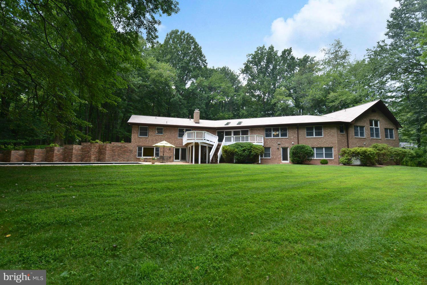 243 Springvale Road Great Falls, VA 22066 - Photo 28 of 30 a front view of a house with a yard table and chairs