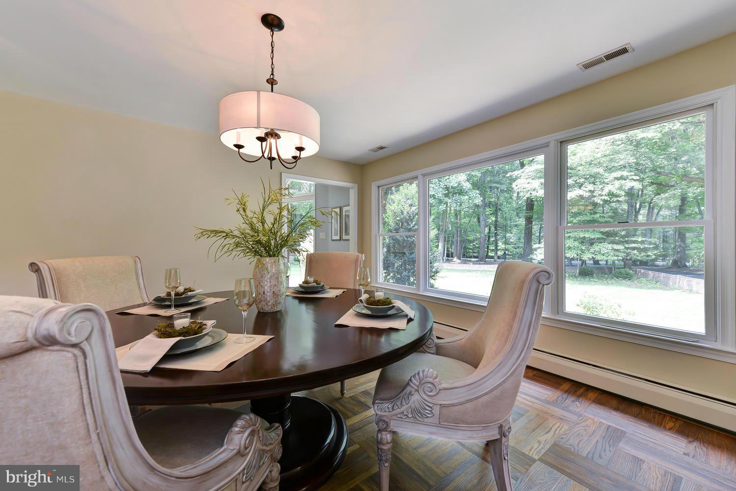 243 Springvale Road Great Falls, VA 22066 - Photo 6 of 30 a view of a dining room with furniture wooden floor and chandelier