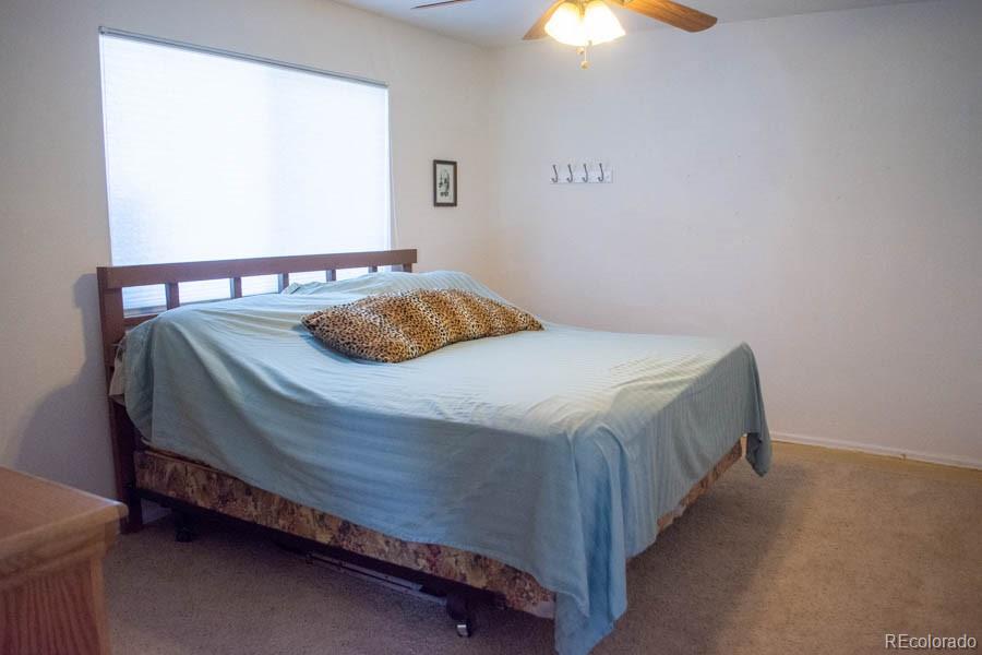 291 Turkey Ridge Road Walsenburg, CO 81089 - Photo 13 of 40 a bedroom with a bed and lamp