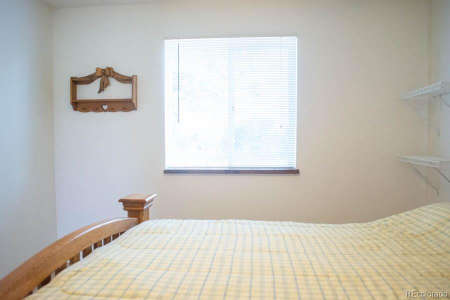 291 Turkey Ridge Road Walsenburg, CO 81089 - Photo 32 of 40 a bedroom with a bed and a window