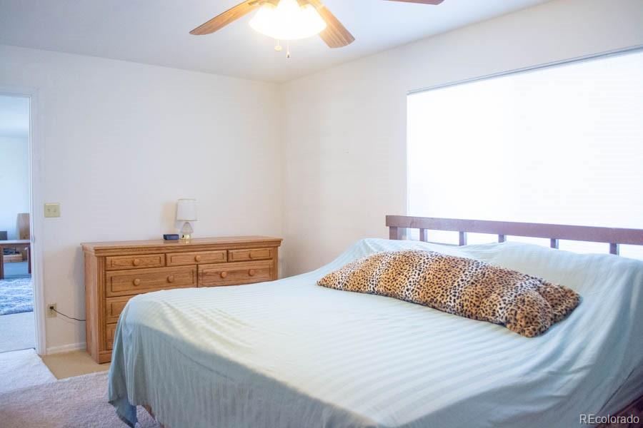 291 Turkey Ridge Road Walsenburg, CO 81089 - Photo 33 of 40 a bedroom with a bed and a chandelier