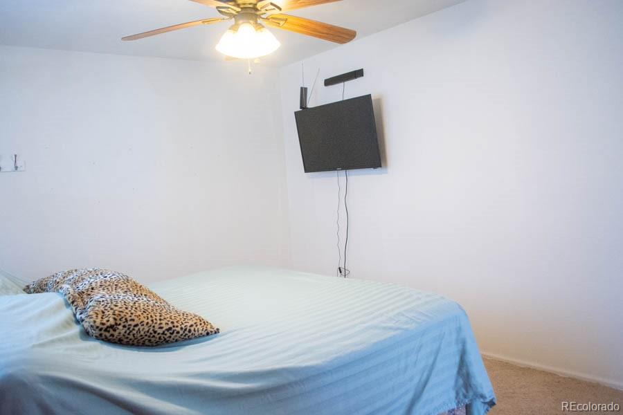 291 Turkey Ridge Road Walsenburg, CO 81089 - Photo 34 of 40 a room with a flat screen tv and a lamp