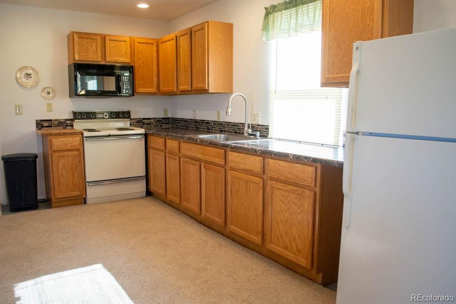 291 Turkey Ridge Road Walsenburg, CO 81089 - Photo 10 of 40 a kitchen with a refrigerator sink and a microwave