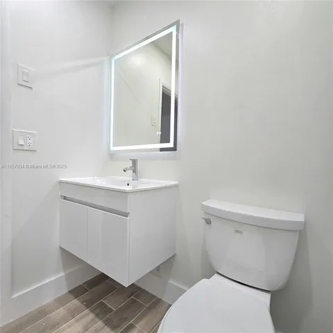 a white toilet sitting next to a bathroom sink